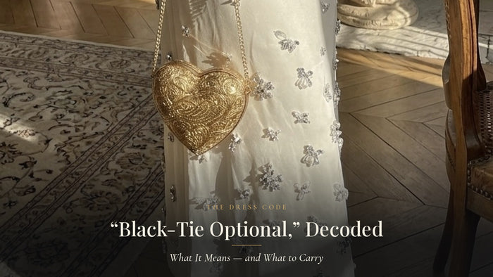 Black-Tie Optional decoded: a gold heart-shaped handmade minaudiere on a chain against an evening gown, by Gullye