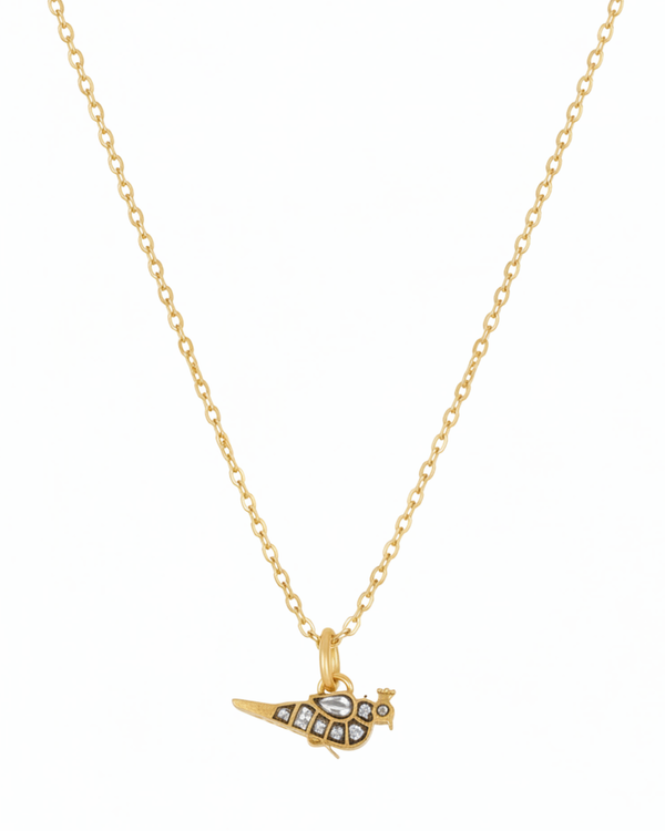Gilded Finch Pendant carried by a model, styled for evening