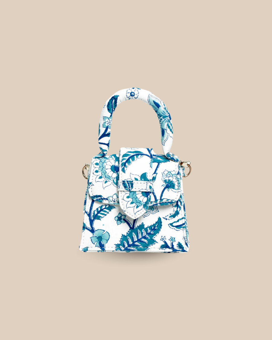 The Porto block-print mini top-handle bag — front view of the blue-and-white floral artisan bag