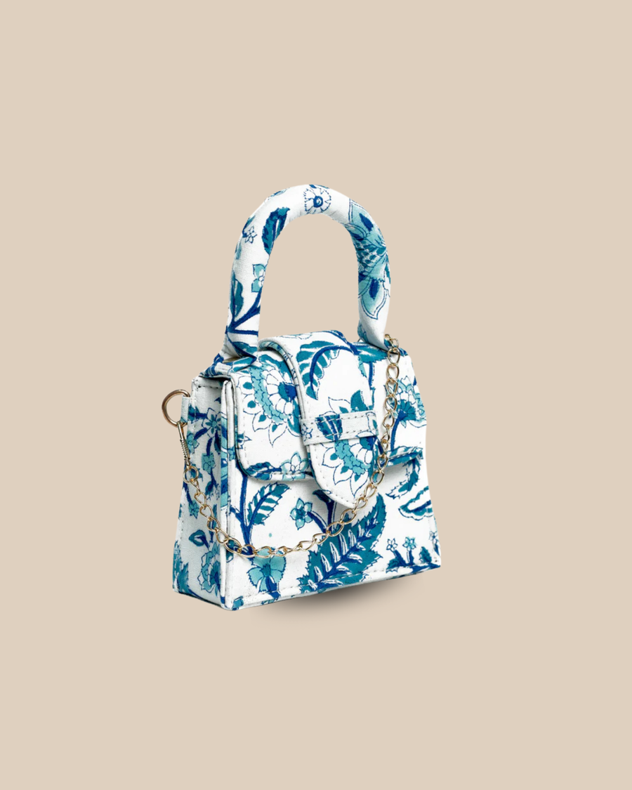 The Porto block-print mini bag — three-quarter view of the blue floral hand-blocked bag