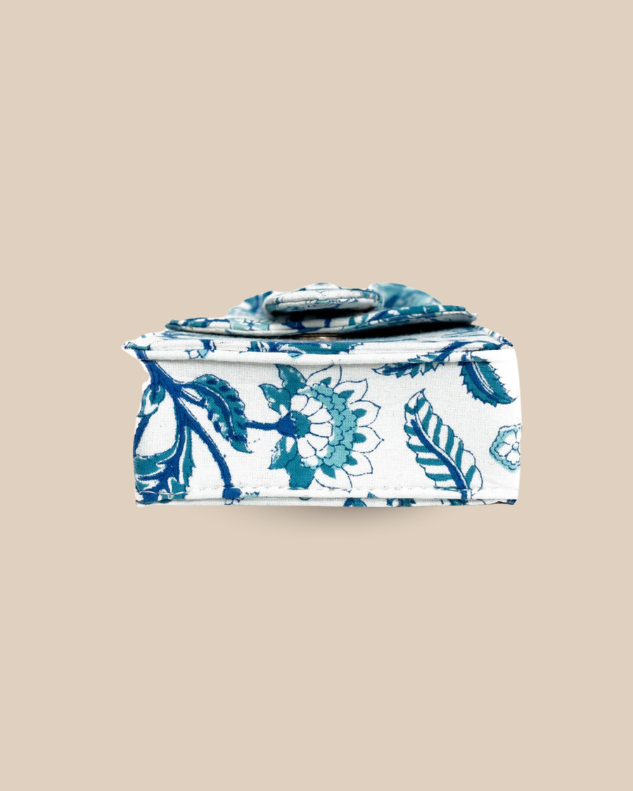 The Porto block-print mini bag — side view of the petite blue-and-white top-handle