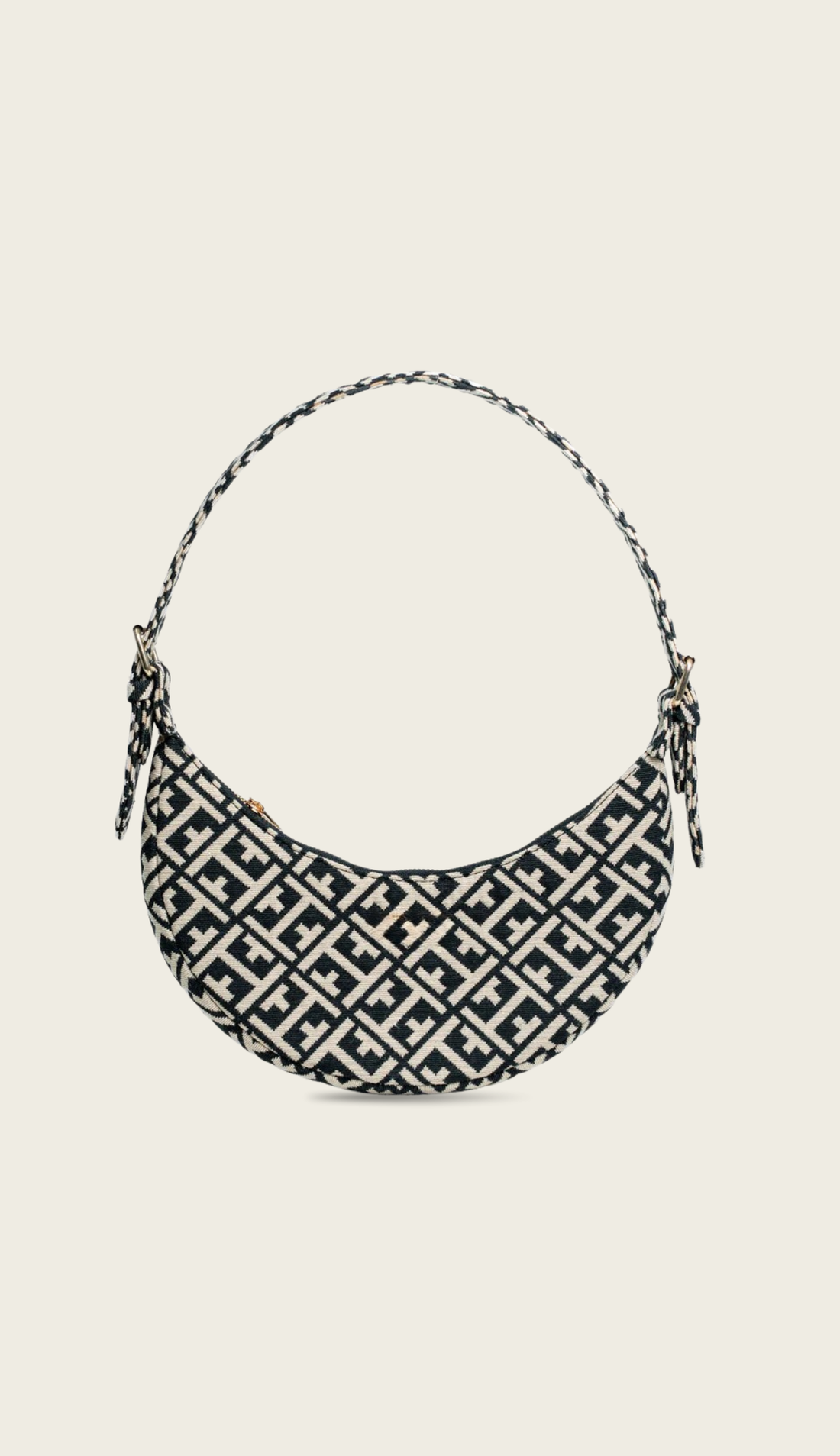 The Greco handbag carried by a model, styled for evening