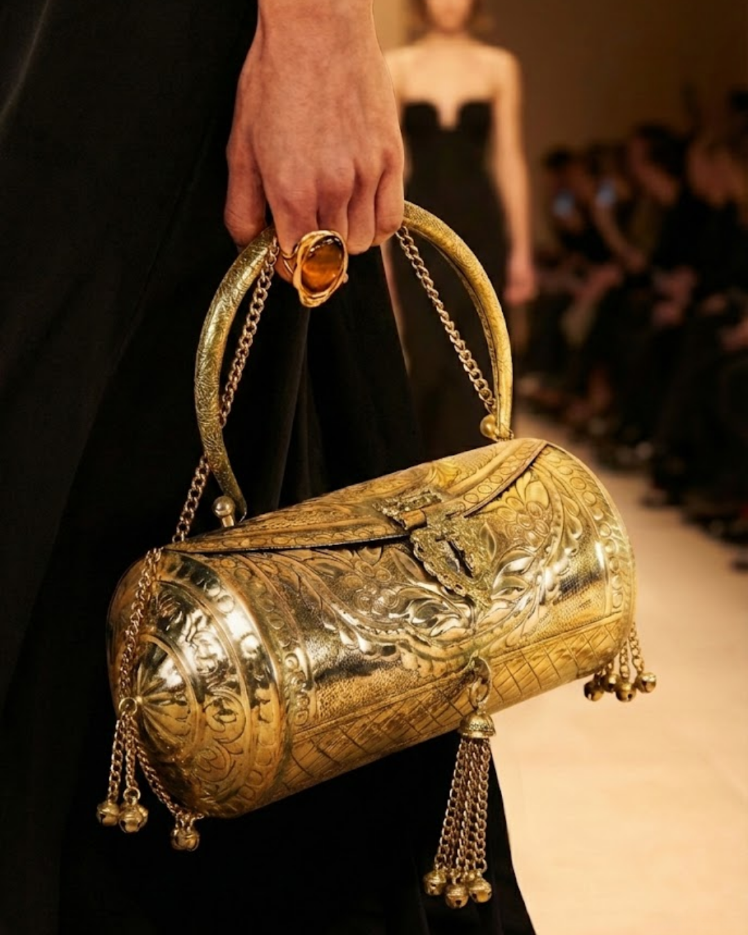 The Dholak minaudière worn by a model as an evening accessory