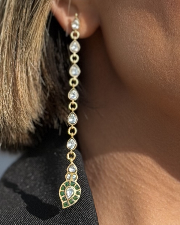 The Emerald-Tip Cascade Earrings styled by a model in an editorial look