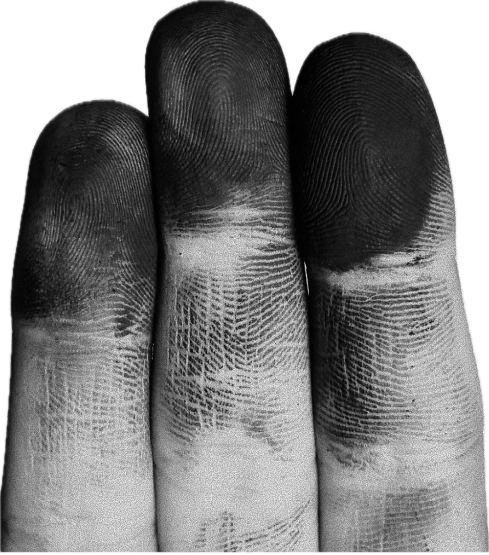 Artisan's fingertips stained with workshop pigment, fingerprints visible