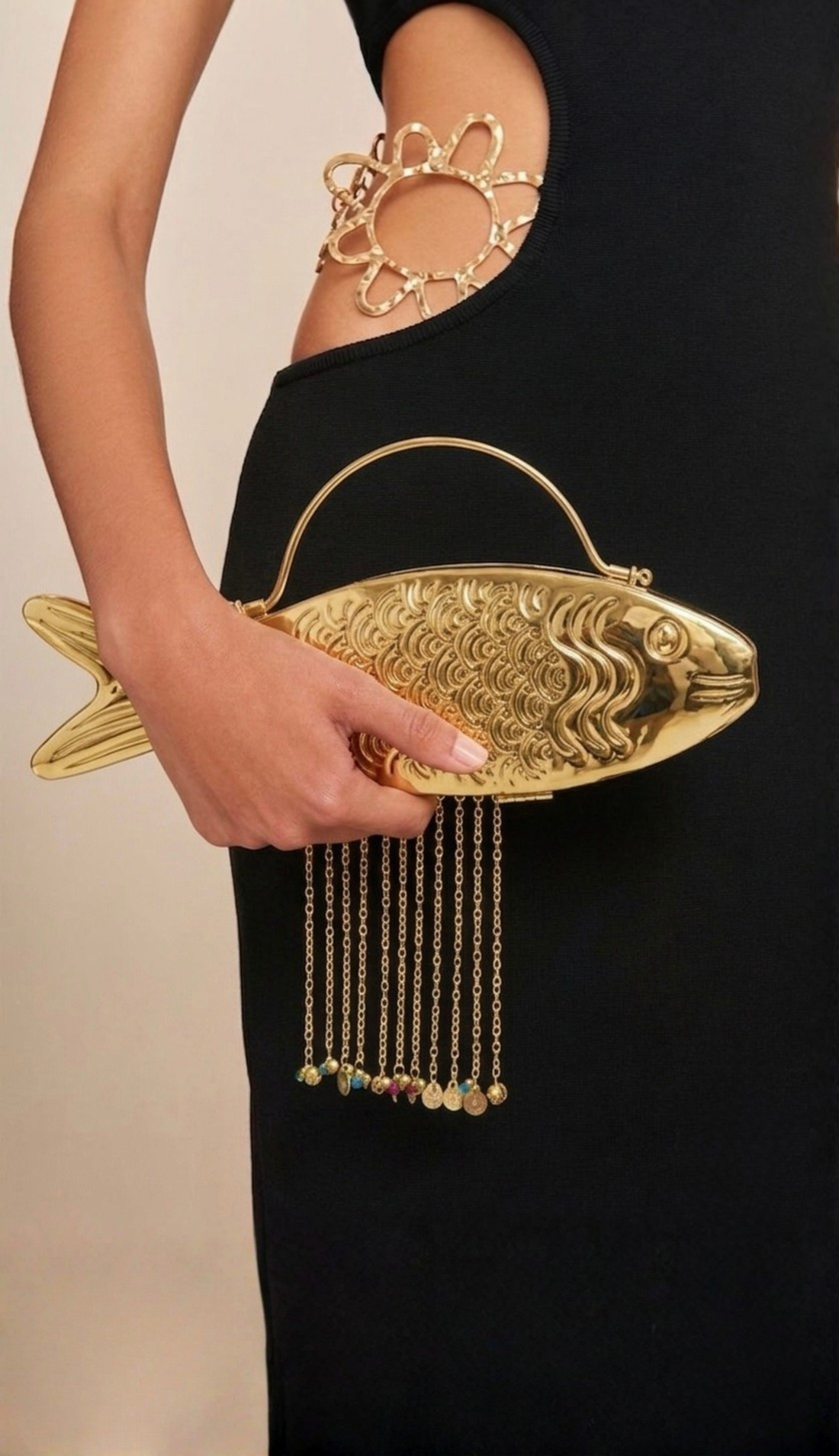 The Monsoon Fish minaudière carried by a model, styled for evening