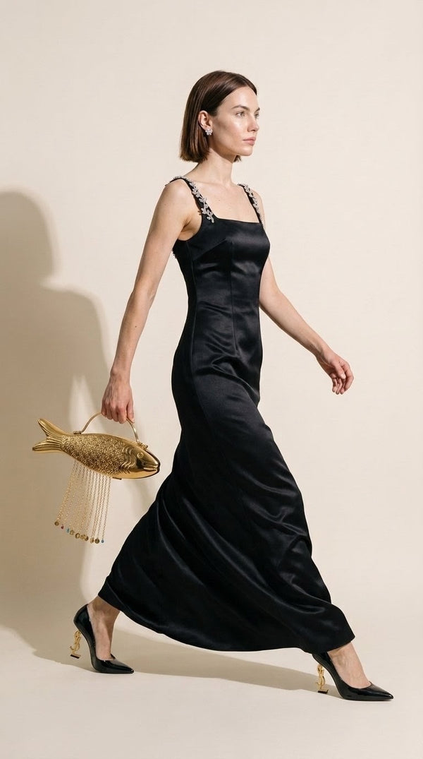 The Monsoon Fish brass clutch carried at the side with a black satin gown
