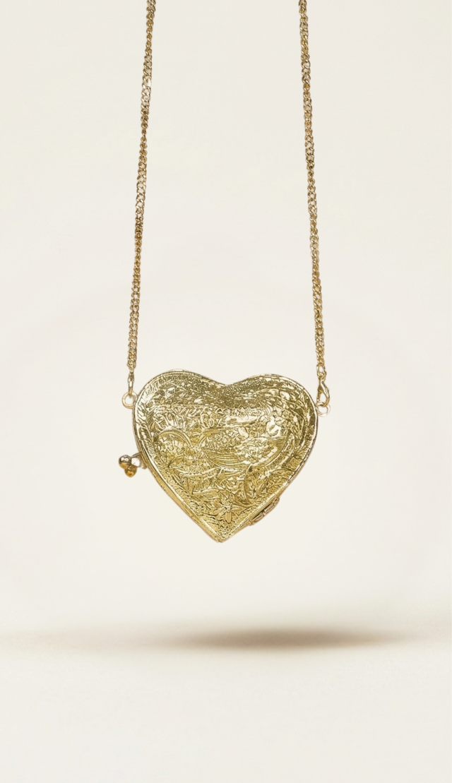 The Amour minaudière carried by a model, styled for evening