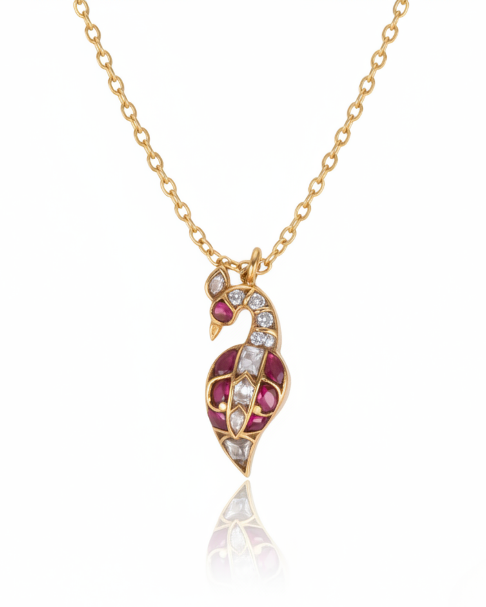 Front of The Crimson Swan Pendant: a gold swan-and-paisley motif inlaid with crimson rubies and rose-cut crystals.
