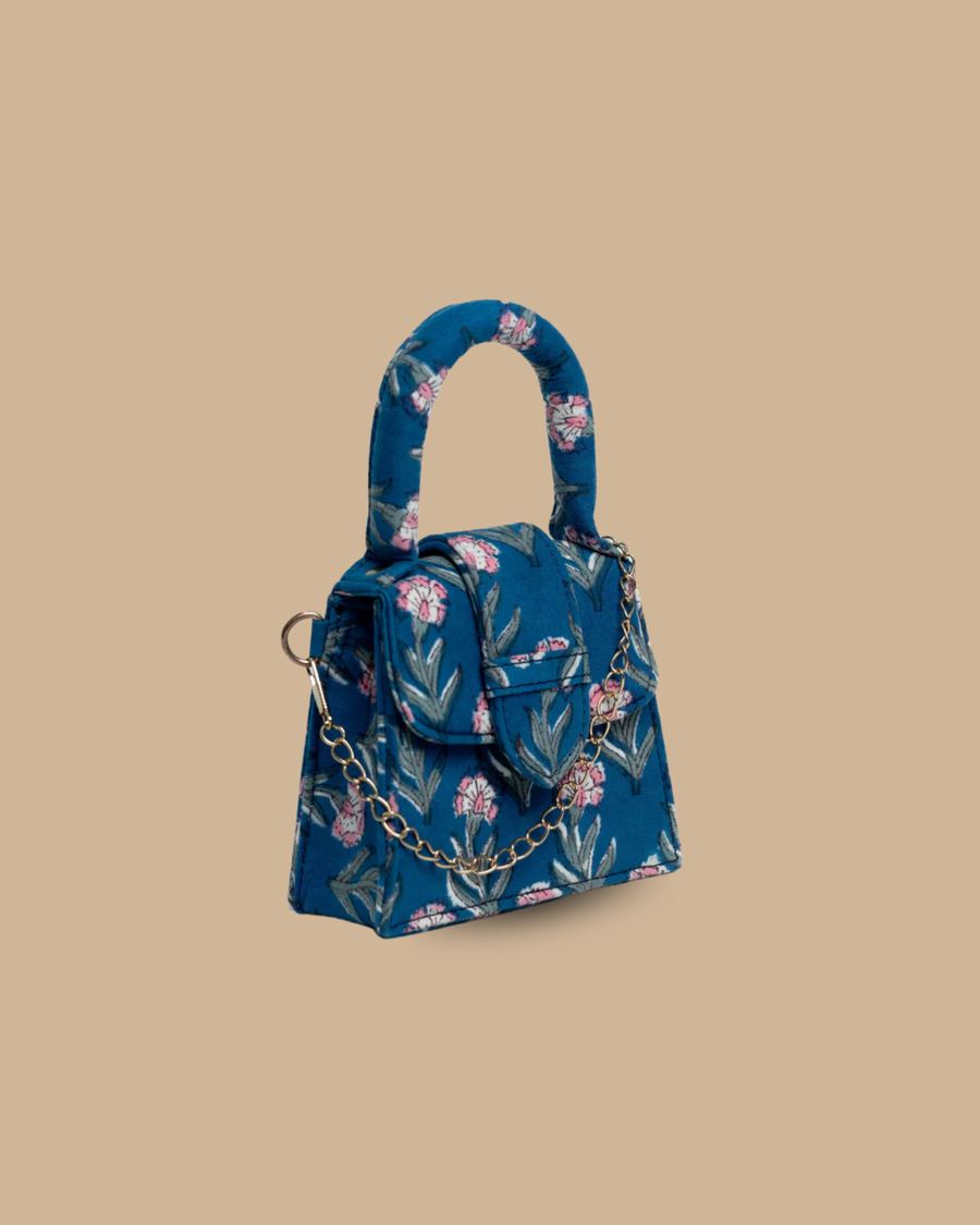 The Soir block-print mini bag — three-quarter view of the blue floral block-print artisan bag