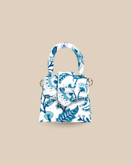 The Porto block-print mini top-handle bag — front view of the blue-and-white floral artisan bag