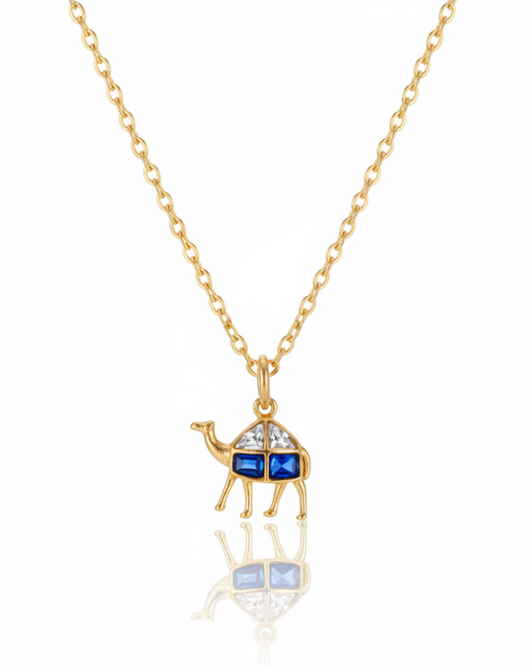 The Nomad Camel Pendant carried by a model, styled for evening