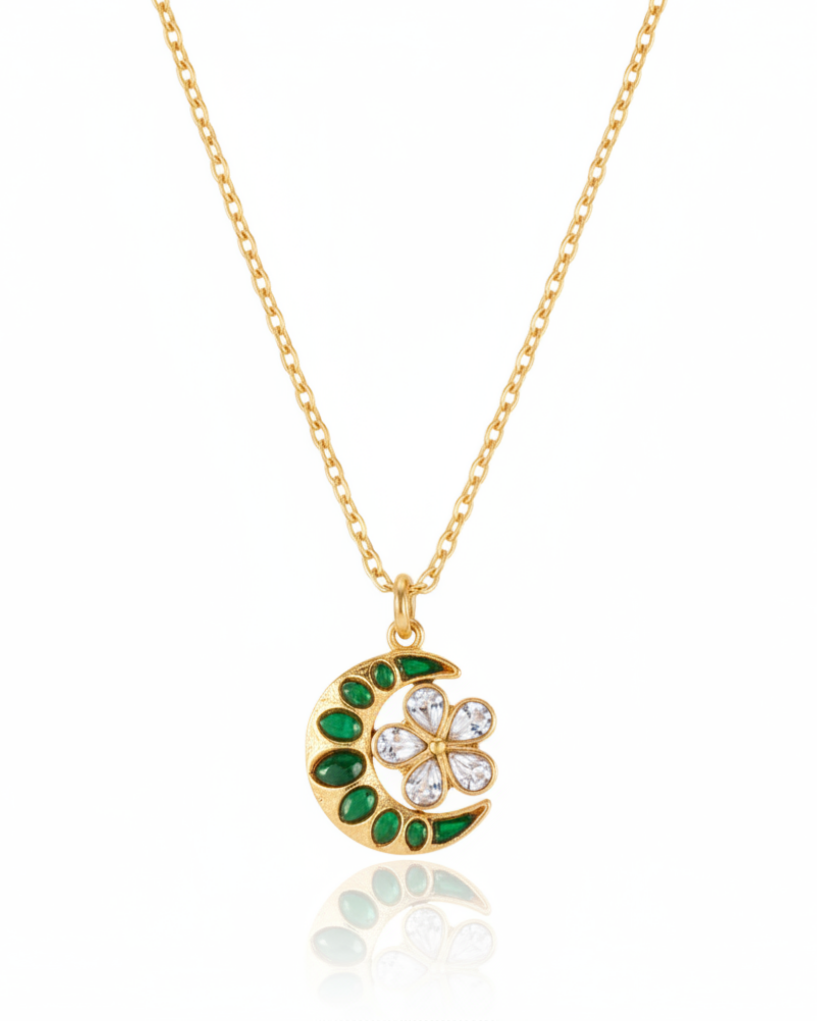 Front of The Midnight Bloom Pendant: a gold crescent moon rimmed with emerald-green stones cradling a rose-cut crystal flower.