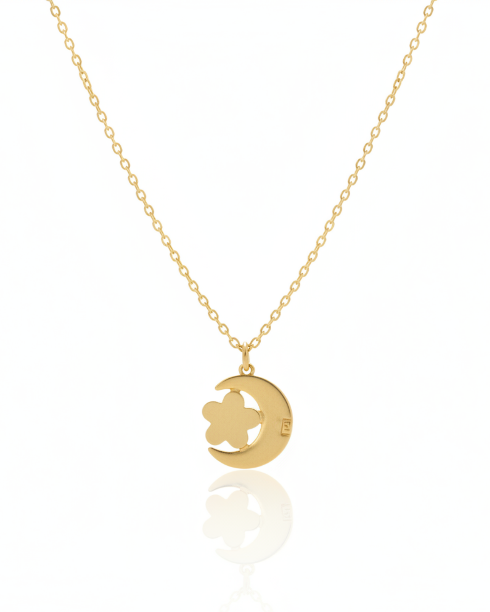 Back of The Midnight Bloom Pendant showing the openwork gold crescent moon and flower silhouette.