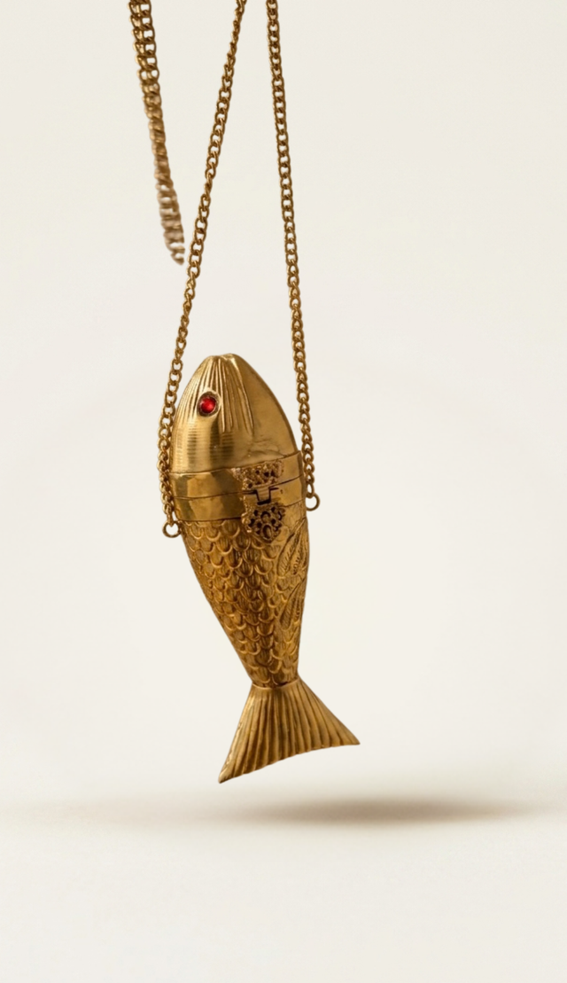 The Siren Fish minaudière carried by a model, styled for evening