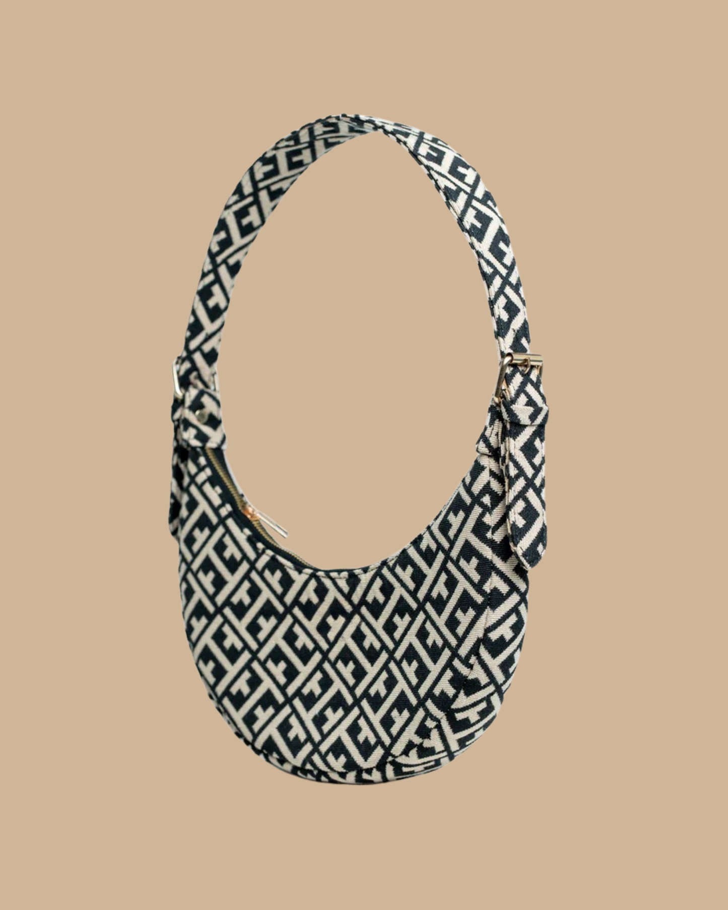 The Greco shoulder bag — three-quarter view of the crescent silhouette in navy jacquard