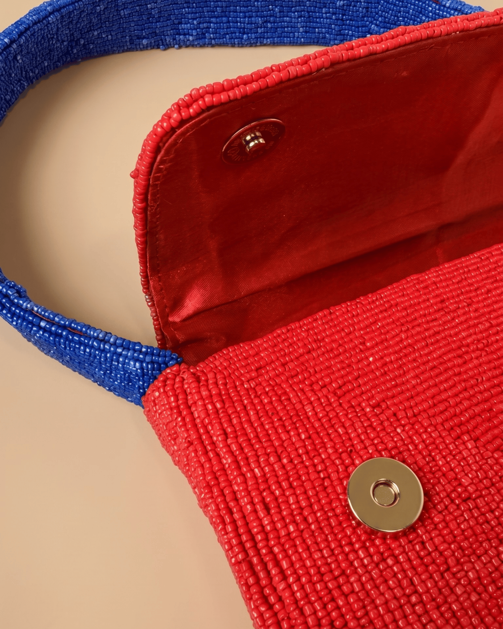 The Rally Buffalo Edition — interior view of the red beaded handbag showing the magnetic snap closure and matching red fabric lining.
