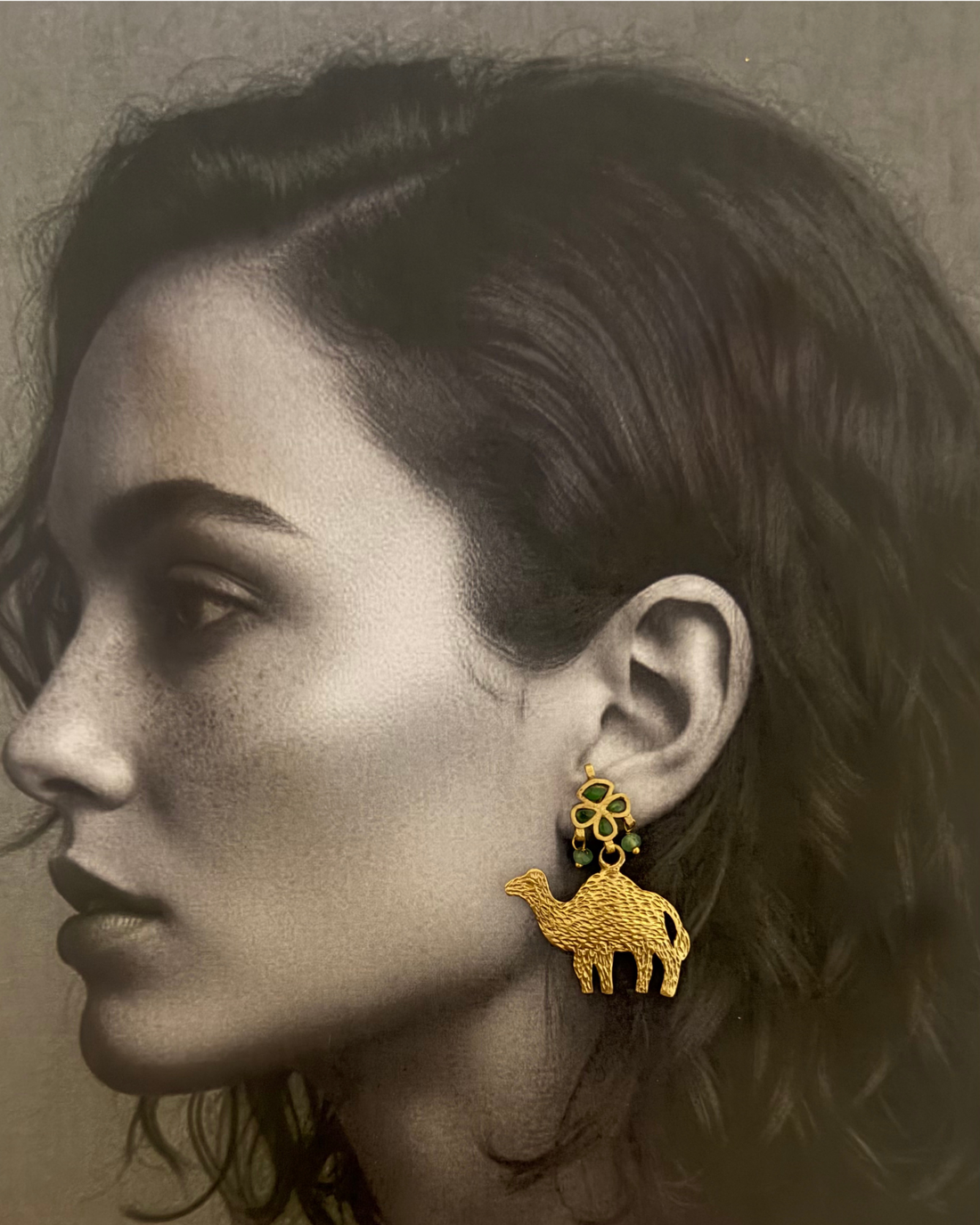 The Nomad Camel Drop worn by a model as an evening accessory