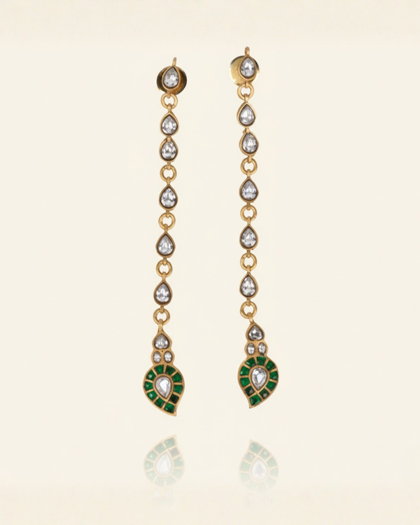 The Emerald-Tip Cascade Earrings carried by a model, styled for evening