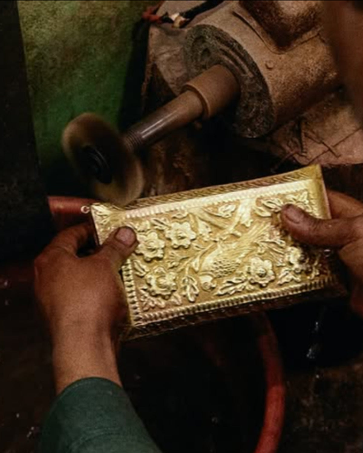 Brass atelier: polishing a hand-cast brass clutch on the buffing wheel
