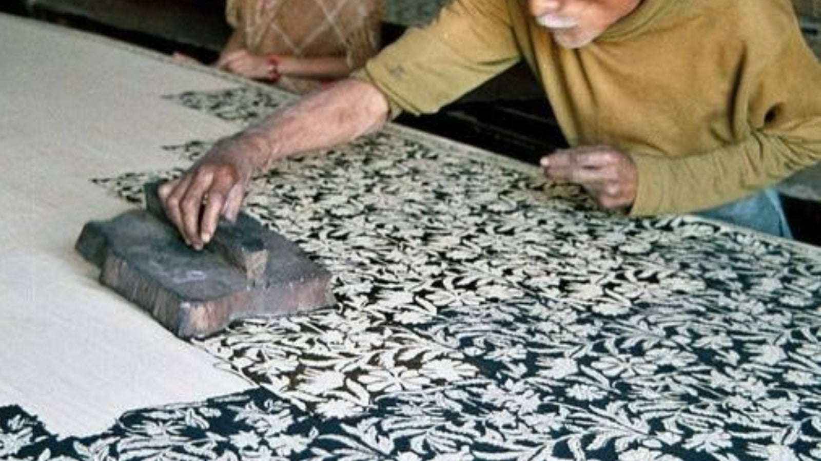 Hand block-printing a floral pattern onto cotton