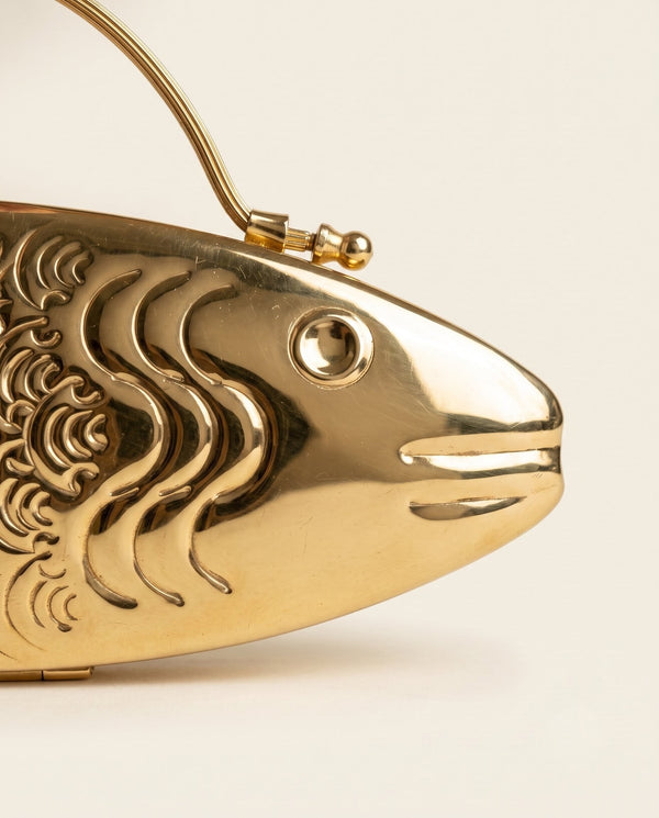 Cast brass head of The Monsoon Fish clutch, showing the eye, mouth and scale relief